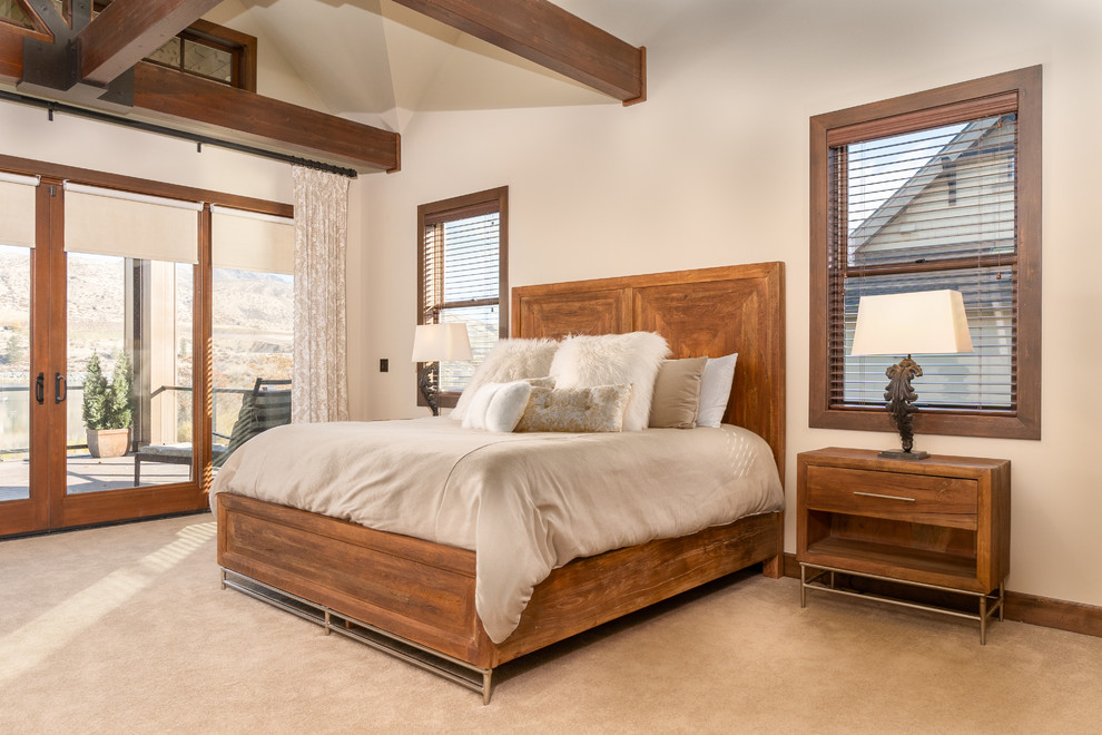 Photo of a large rustic master bedroom in Seattle with beige walls, carpet and blue floors.