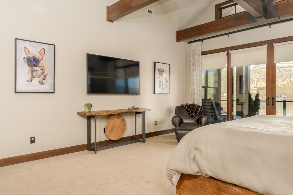 Large rustic master bedroom in Seattle with beige walls, carpet and blue floors.