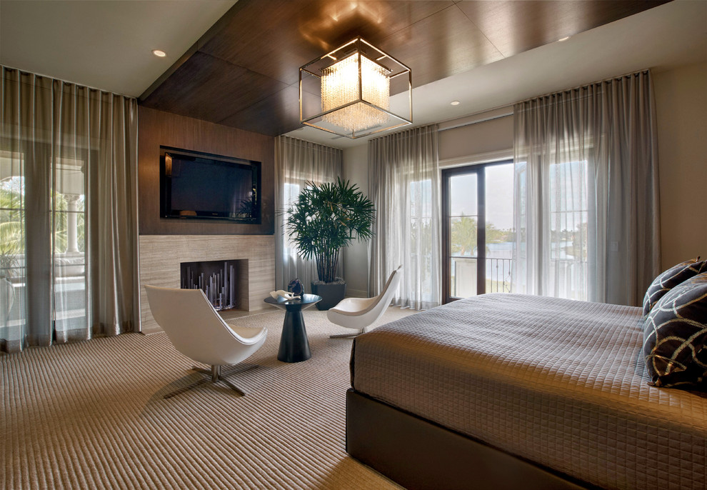 マイアミにある広いコンテンポラリースタイルのおしゃれな主寝室 (カーペット敷き、標準型暖炉、ベージュの壁、シアーカーテン) のインテリア
