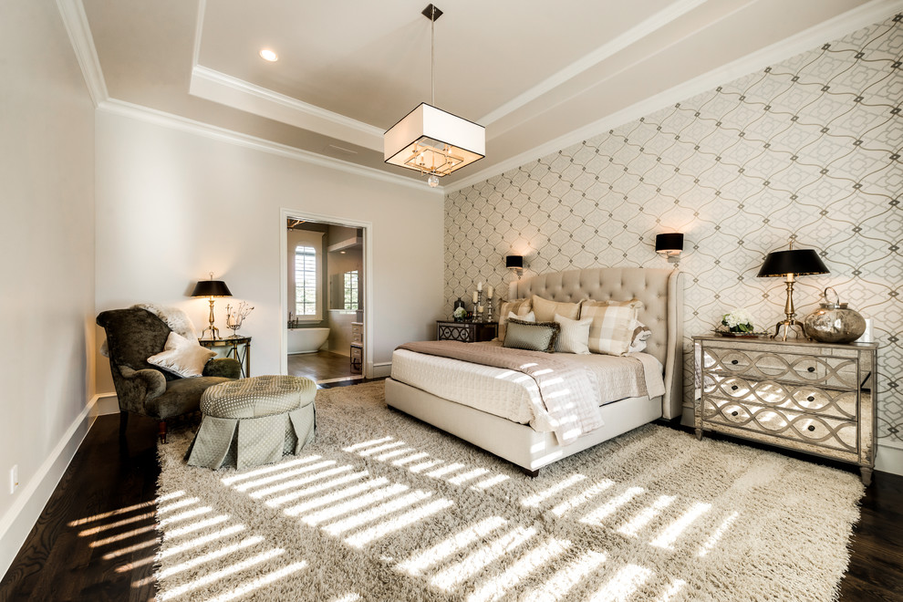 Photo of a large traditional master bedroom in Dallas with beige walls and dark hardwood flooring.
