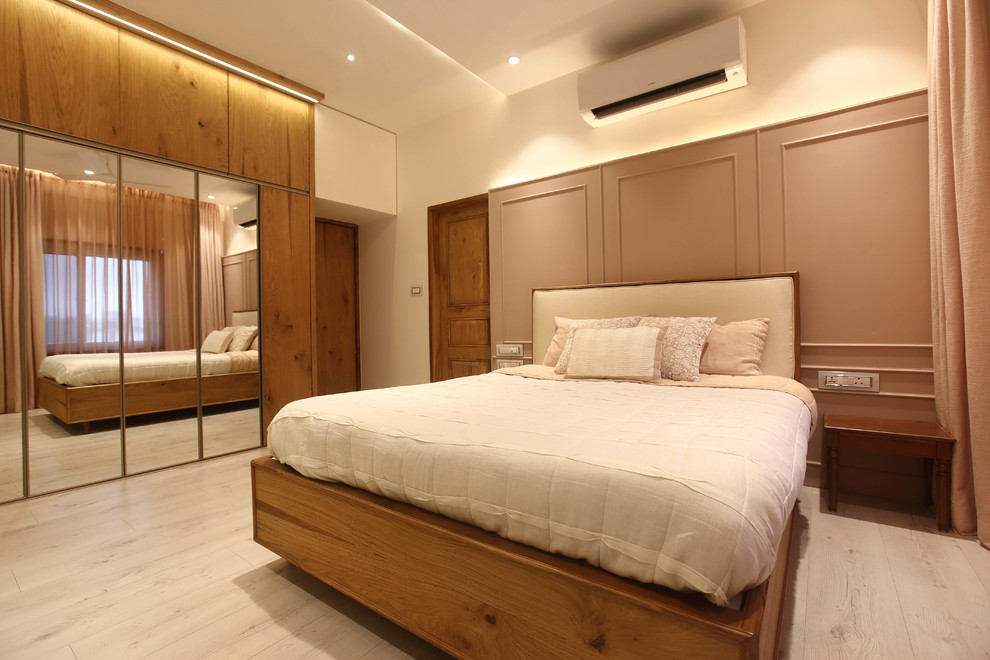 Bedroom - mid-sized contemporary guest light wood floor bedroom idea in Pune with white walls