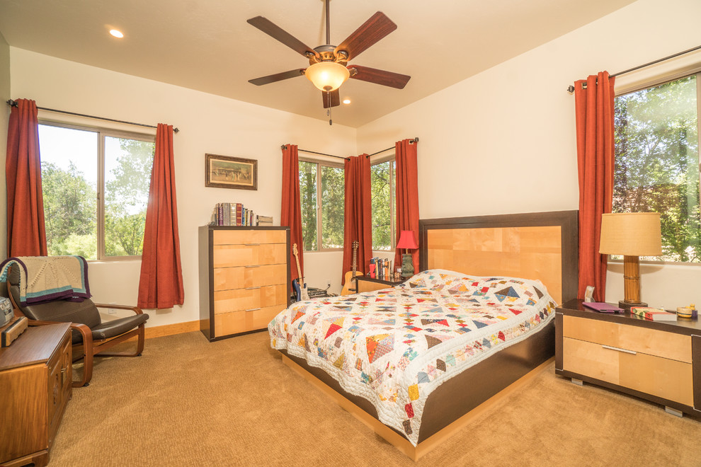 Mid-sized southwest master carpeted and beige floor bedroom photo in Other with beige walls