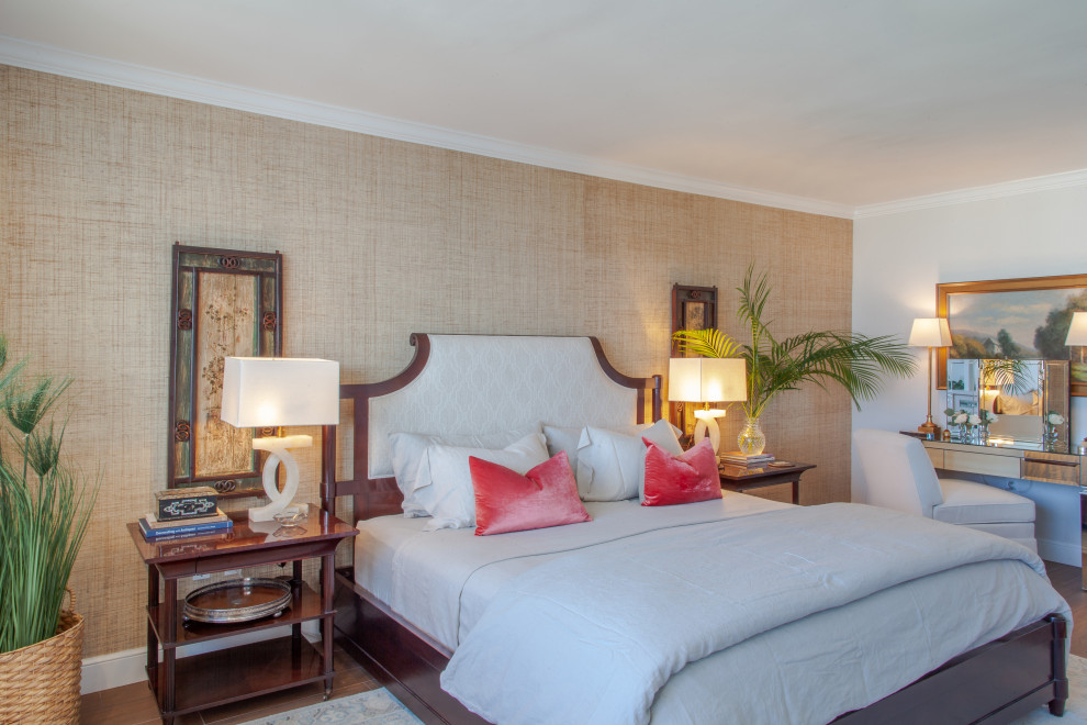 This is an example of a beach style master bedroom in Miami with wallpapered walls.