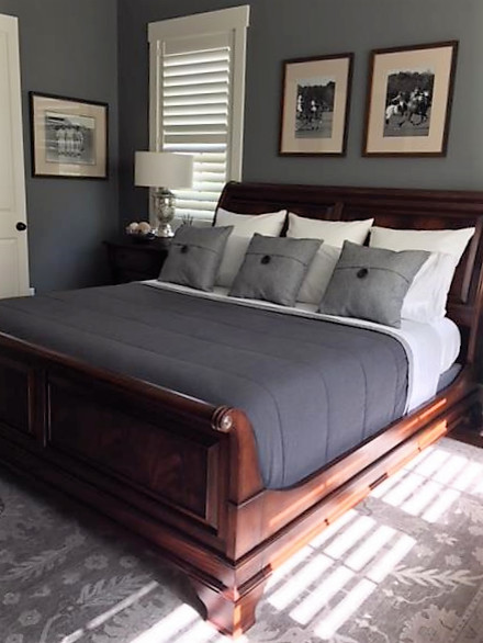 Example of a mid-sized eclectic guest medium tone wood floor and brown floor bedroom design in Other with no fireplace and gray walls
