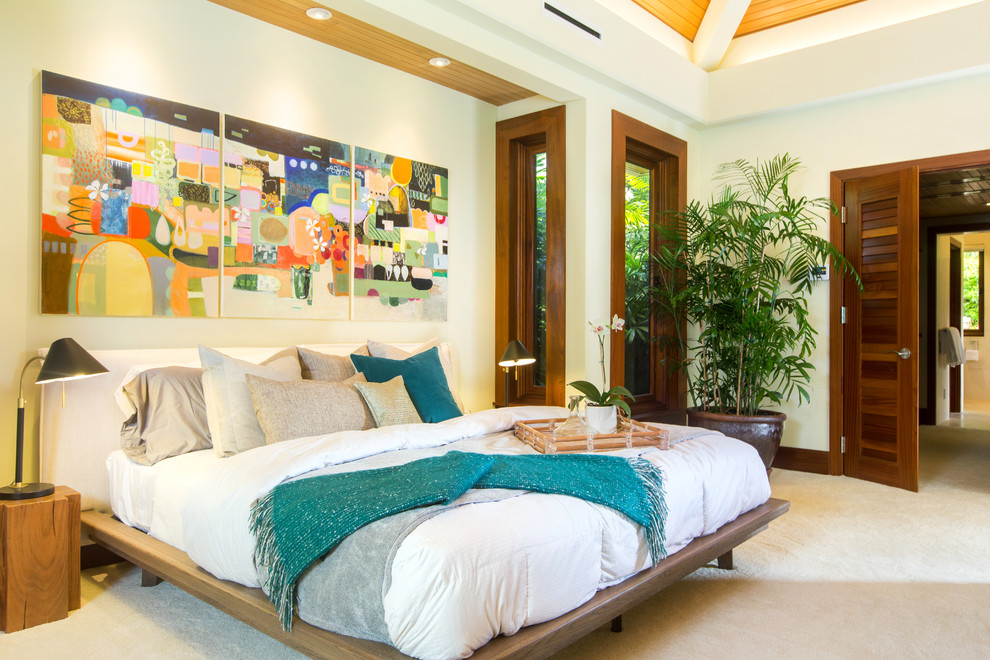 Photo of a large world-inspired master bedroom in Hawaii with white walls, carpet, no fireplace and beige floors.