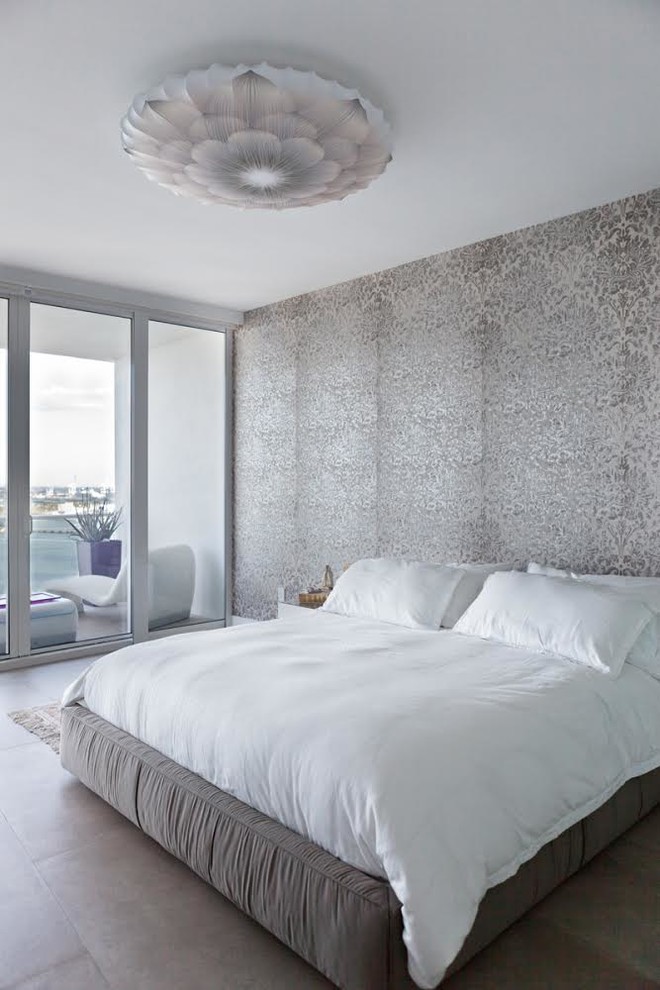 This is an example of a contemporary grey and white and grey and silver bedroom in Miami with multi-coloured walls.
