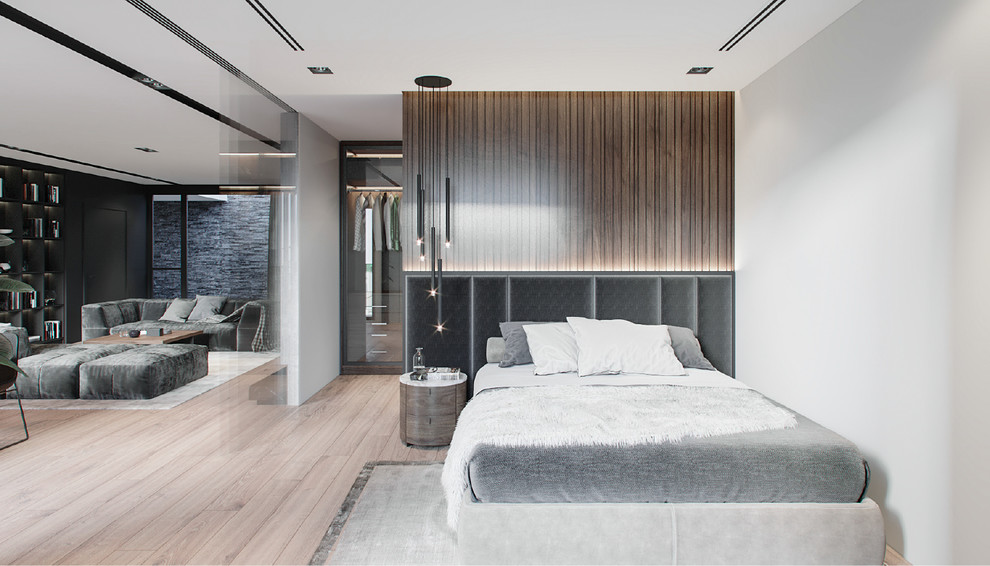 Large minimalist master medium tone wood floor and beige floor bedroom photo in New York with gray walls