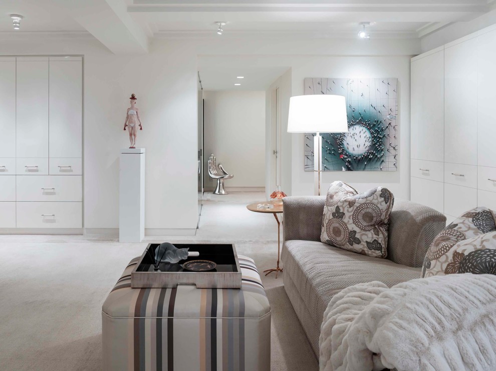 Contemporary master bedroom in New York with white walls, carpet and no fireplace.