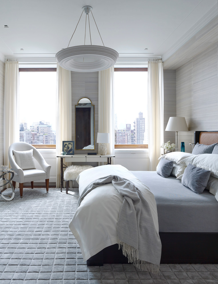 Traditional master bedroom in New York with grey walls and carpet.