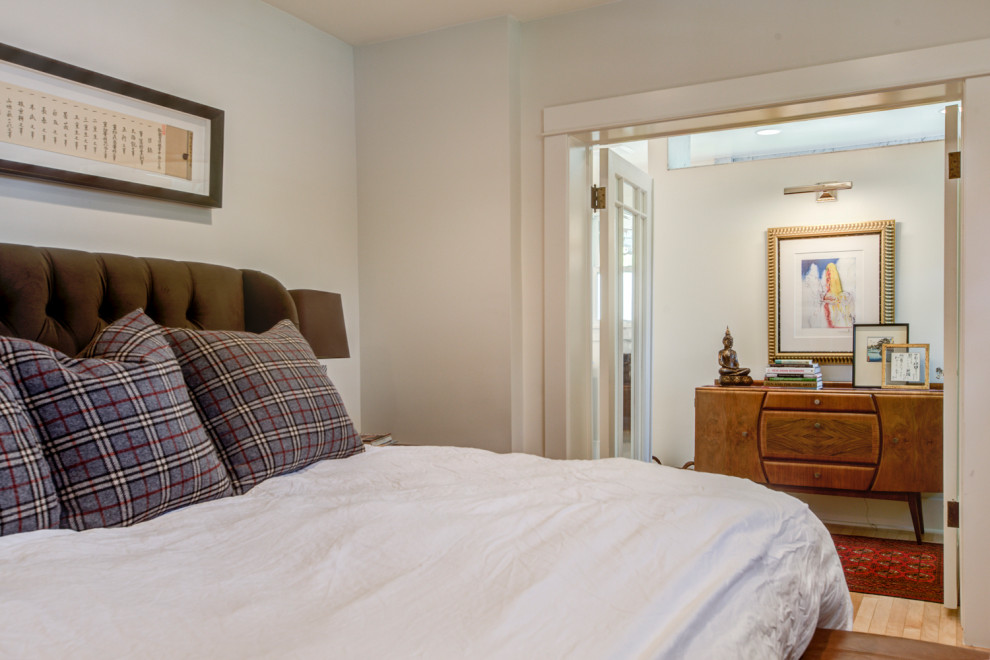 Ejemplo de dormitorio principal tradicional de tamaño medio con paredes blancas, suelo de madera clara y suelo amarillo