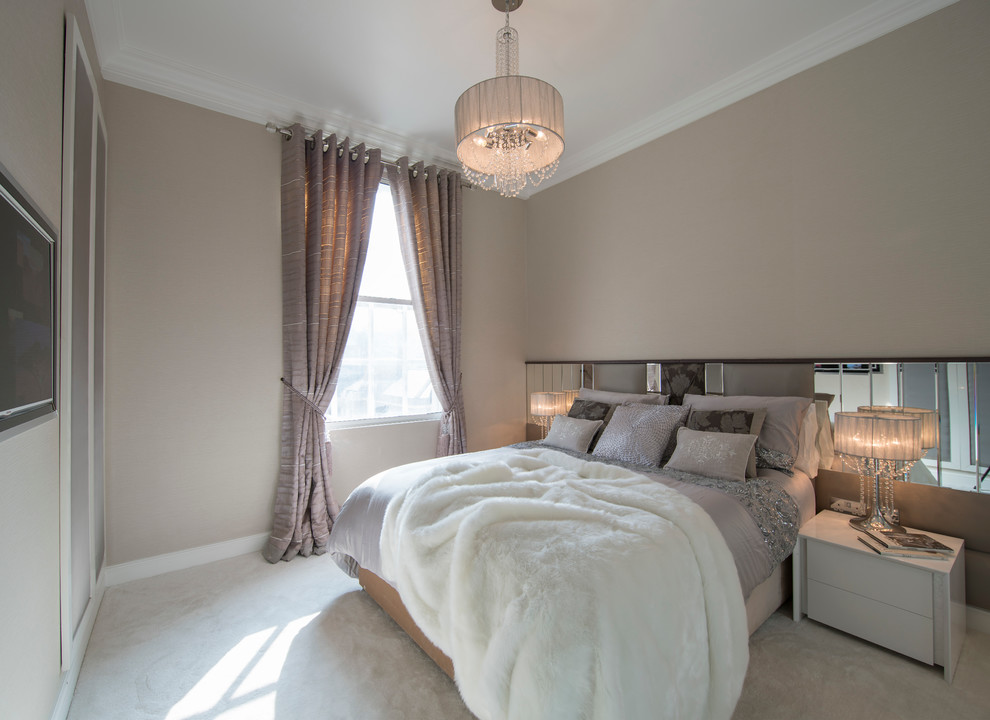Inspiration for a medium sized contemporary guest bedroom in London with beige walls and carpet.