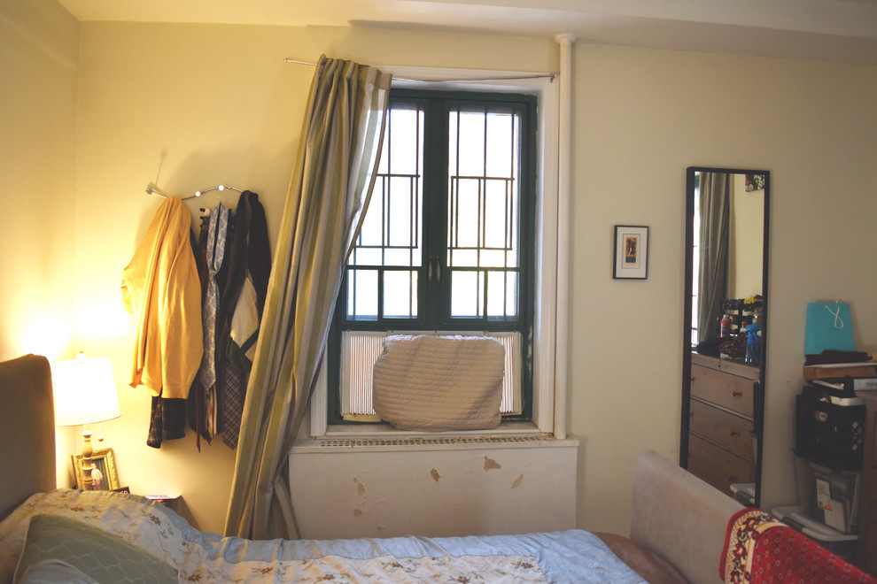 Medium sized vintage master bedroom in New York with blue walls, dark hardwood flooring, no fireplace and brown floors.