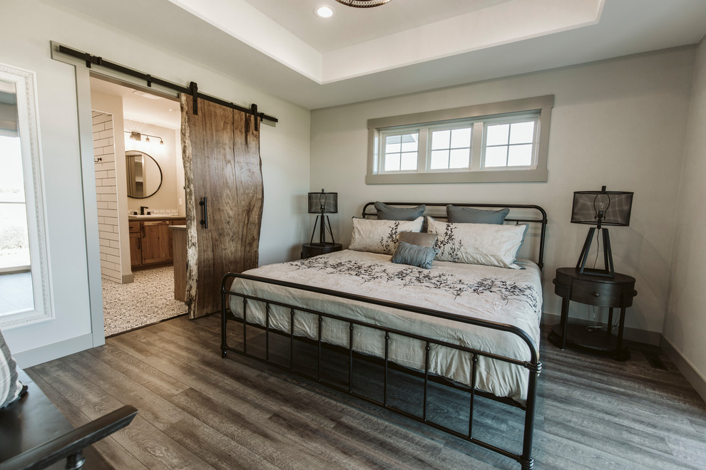 Inspiration for a mid-sized farmhouse master vinyl floor and brown floor bedroom remodel in Other with white walls