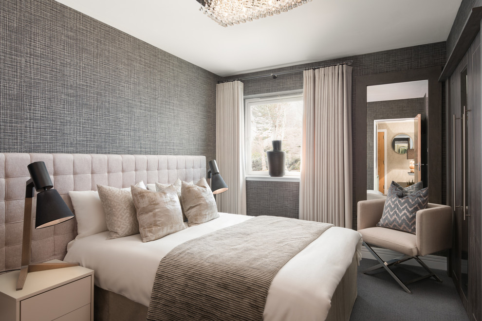 Large modern master bedroom in London with grey walls and carpet.