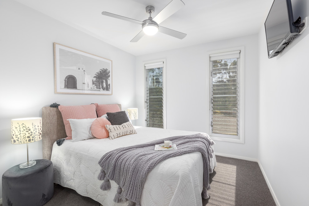 Maritimes Schlafzimmer mit weißer Wandfarbe, Teppichboden und grauem Boden in Sonstige
