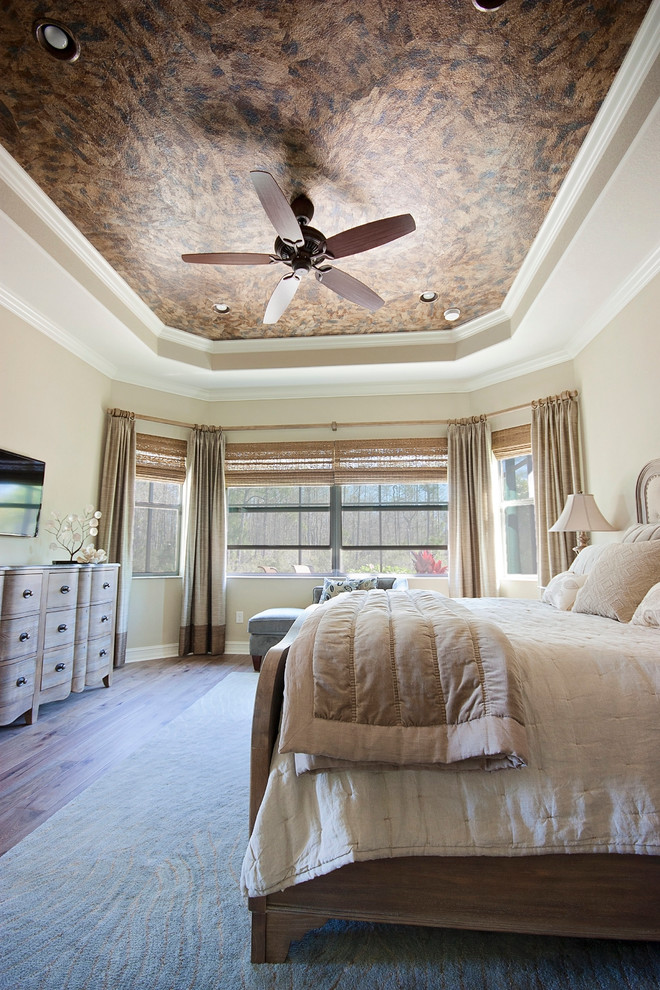 Large romantic master bedroom in Miami with beige walls and brown floors.