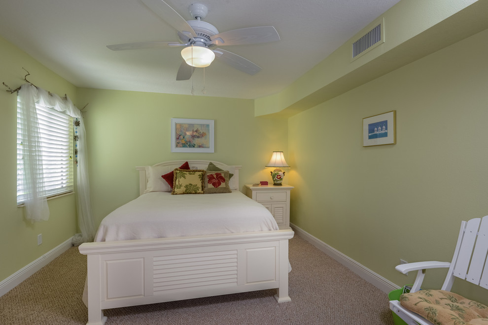 Inspiration for a mid-sized coastal guest carpeted bedroom remodel in Tampa with green walls
