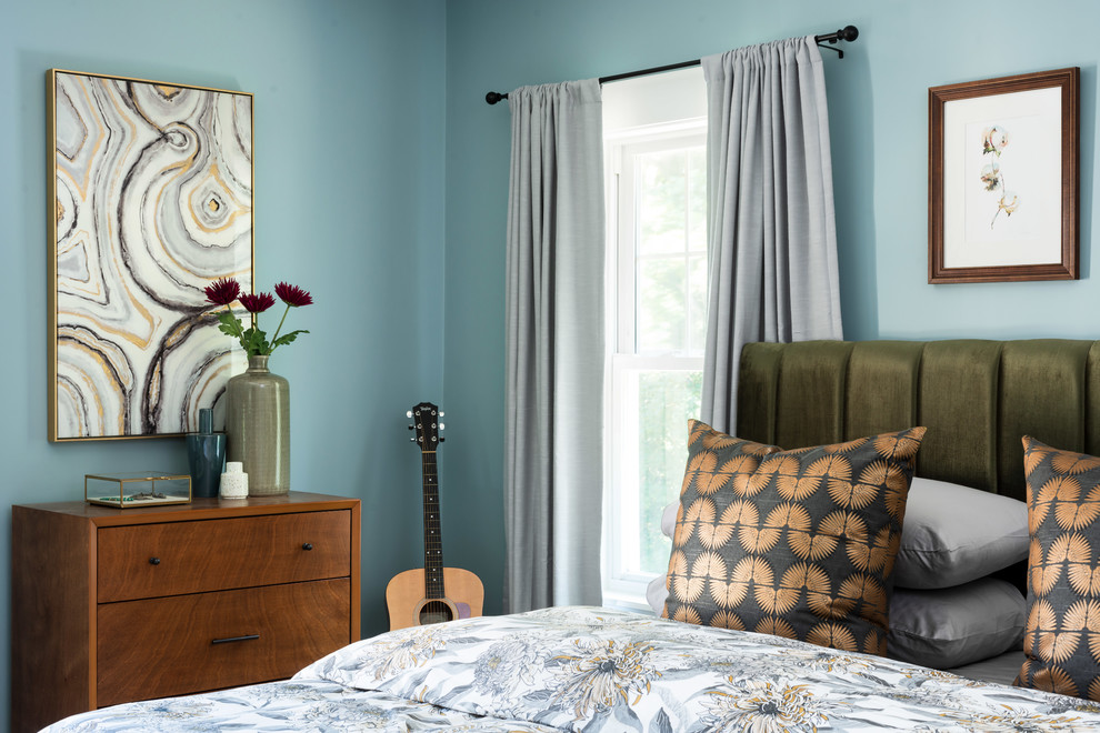 Mid-sized eclectic master medium tone wood floor and multicolored floor bedroom photo in Boston with blue walls