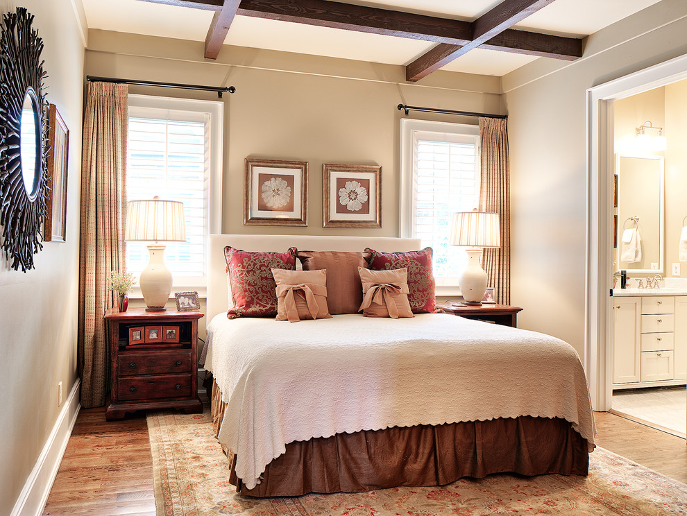 Esempio di una camera matrimoniale chic con pareti beige, pavimento in legno massello medio e pavimento marrone