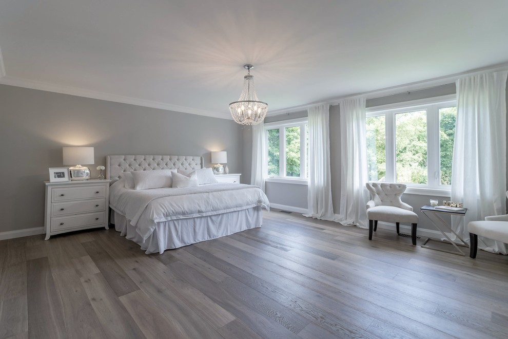 Large master light wood floor and brown floor bedroom photo in Toronto with gray walls