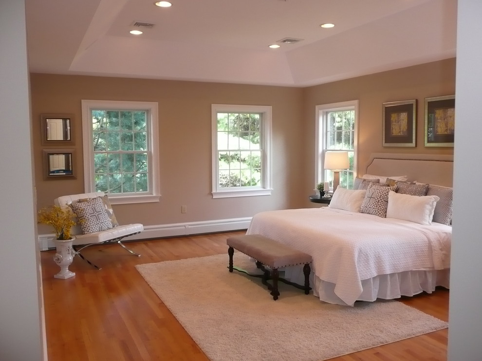Example of a large classic master light wood floor bedroom design in Boston with beige walls