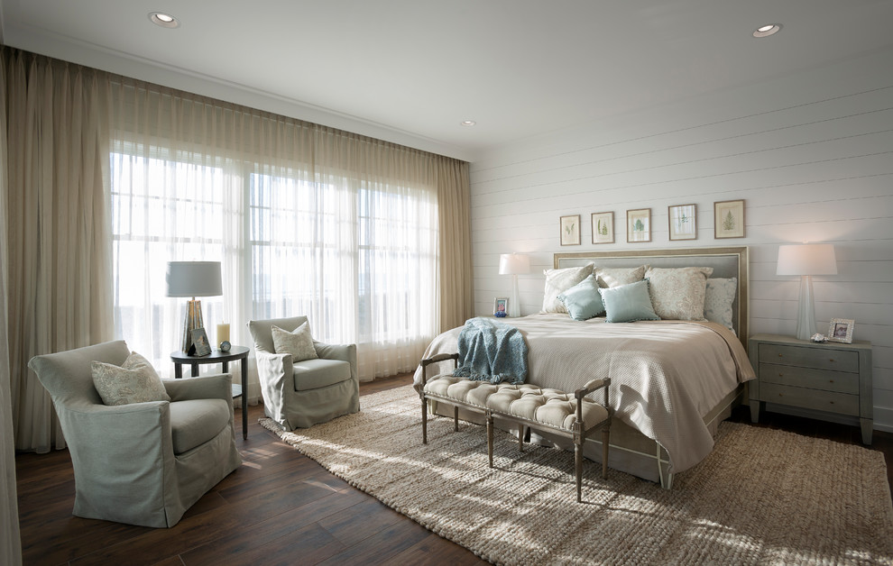 チャールストンにある広いビーチスタイルのおしゃれな主寝室 (白い壁、無垢フローリング、暖炉なし、茶色い床)