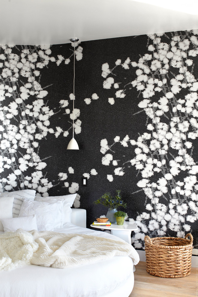 Photo of a contemporary bedroom in Orange County with black walls.