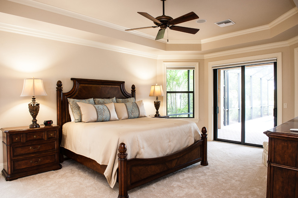 Example of a mid-sized tuscan guest carpeted and beige floor bedroom design in Tampa with beige walls and no fireplace