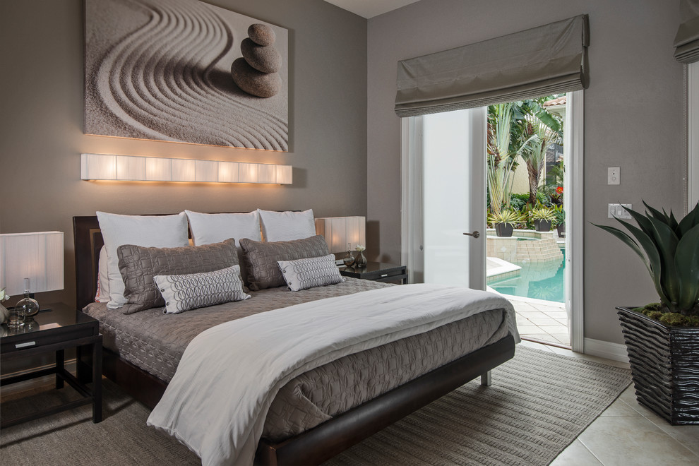 This is an example of a contemporary master bedroom in Miami with grey walls and no fireplace.