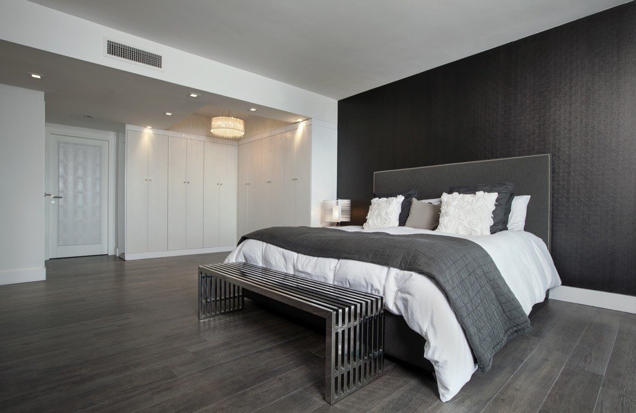 Photo of a medium sized contemporary master bedroom in Miami with black walls and dark hardwood flooring.