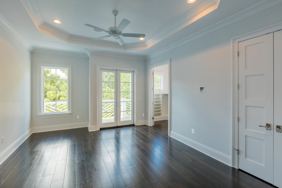 Example of a large classic master dark wood floor bedroom design in Orlando with gray walls