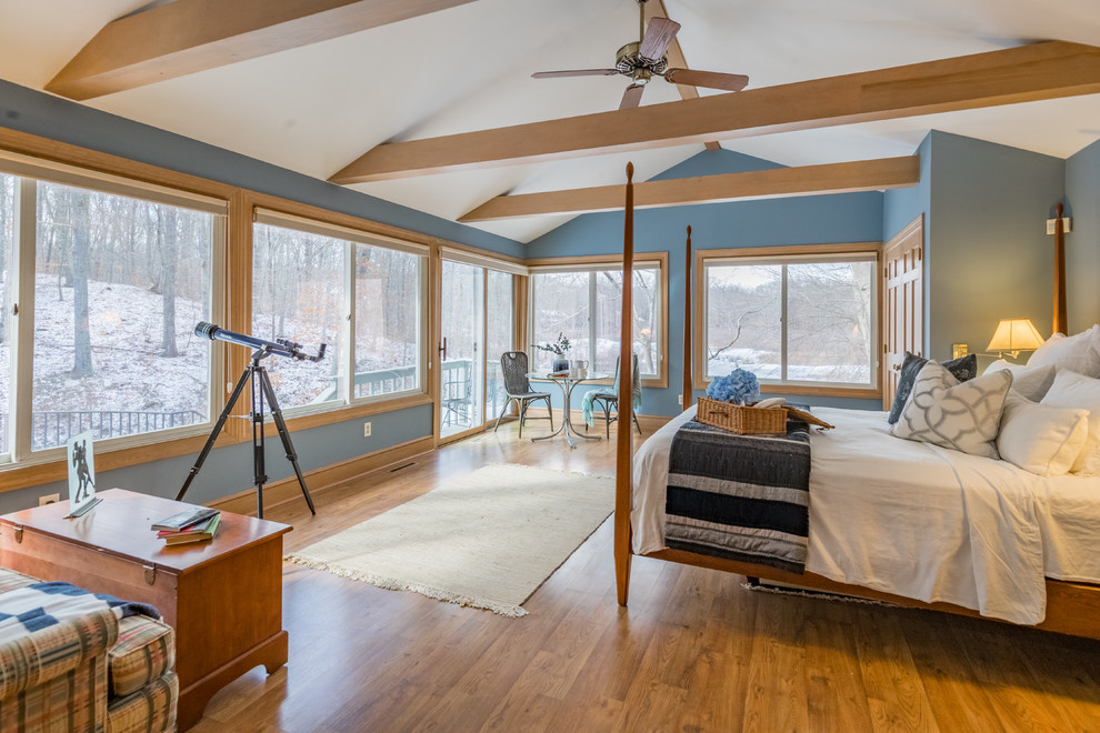 Photo of a rural bedroom in Bridgeport with blue walls, medium hardwood flooring and brown floors.