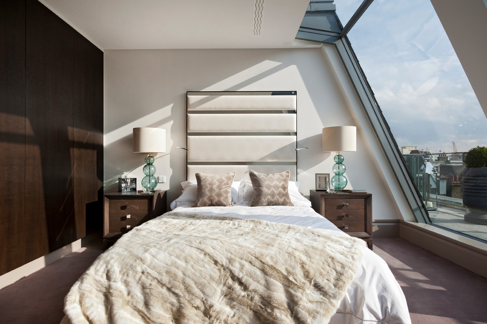 Photo of a contemporary bedroom in London with white walls, carpet and grey floors.