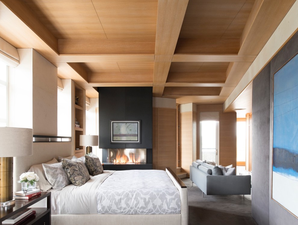 バンクーバーにあるトランジショナルスタイルのおしゃれな主寝室 (グレーの壁、コンクリートの床、標準型暖炉、グレーとブラウン) のレイアウト