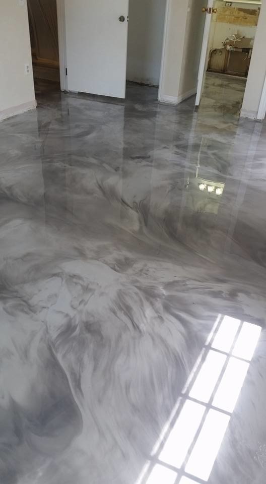 Immagine di una camera degli ospiti contemporanea di medie dimensioni con pavimento in cemento
