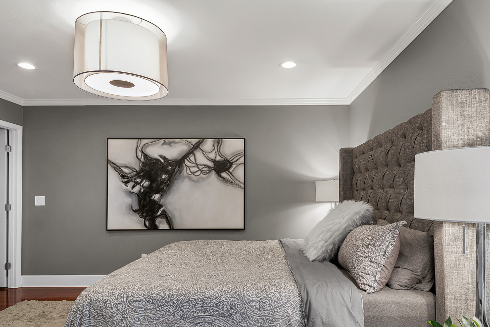Large modern master bedroom in Tampa with grey walls, dark hardwood flooring and brown floors.