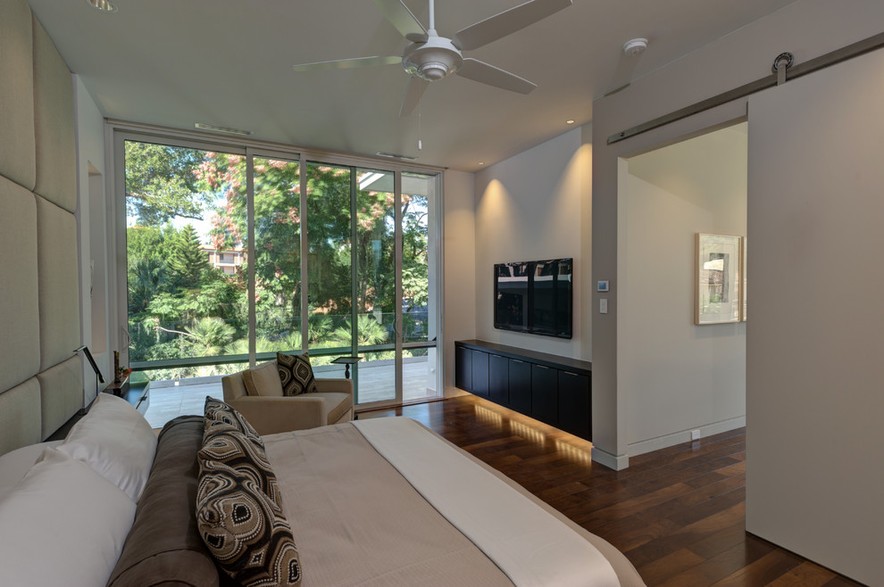 Inspiration for a medium sized modern master bedroom in Orlando with beige walls and dark hardwood flooring.