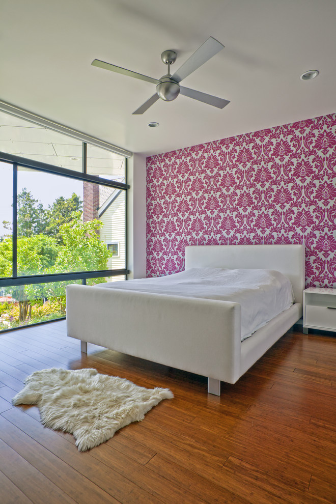 Trendy medium tone wood floor bedroom photo in Seattle with multicolored walls