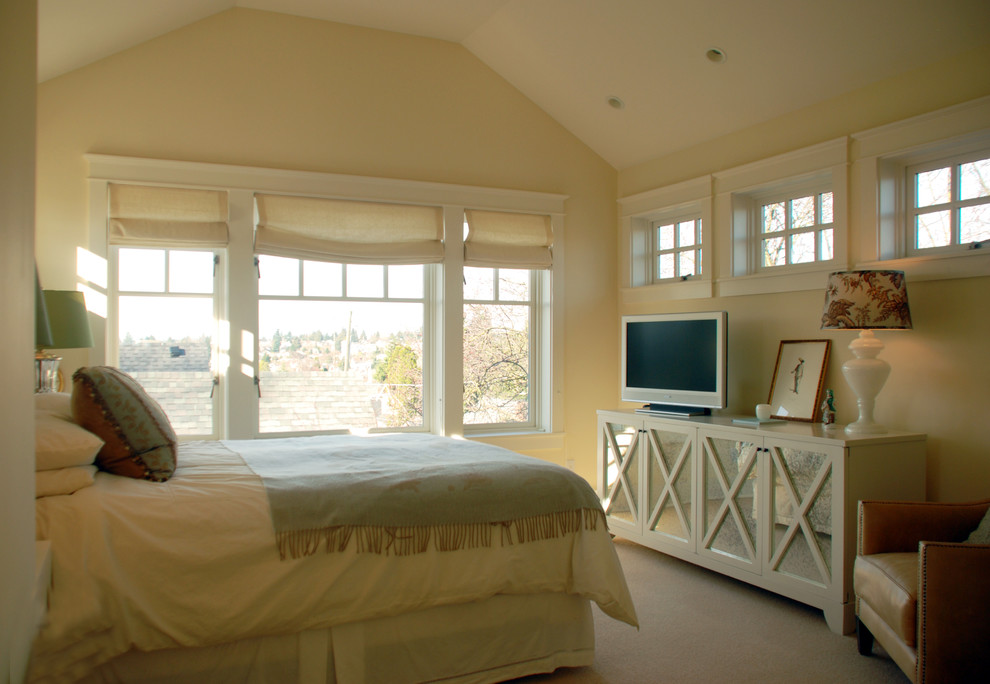 This is an example of a traditional master bedroom in Seattle with beige walls and carpet.