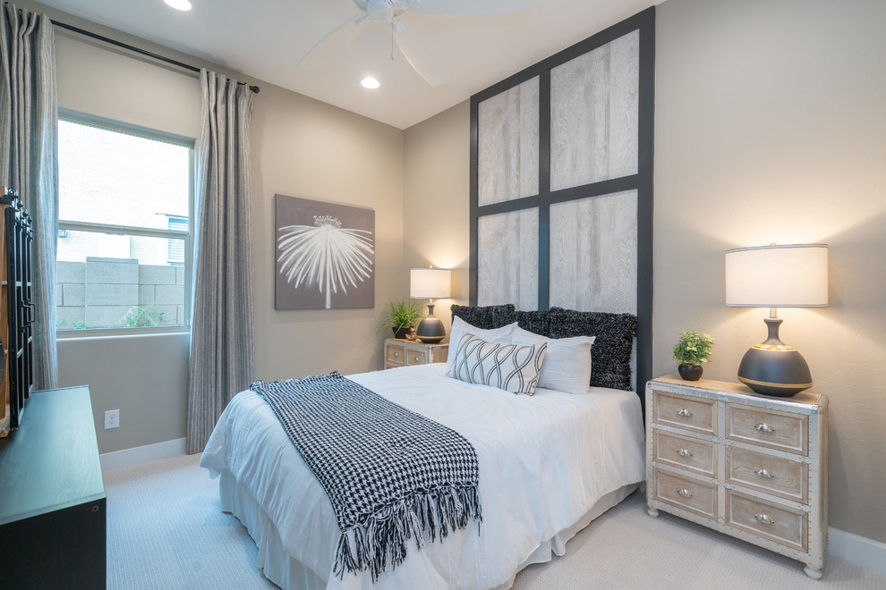 This is an example of a medium sized contemporary guest bedroom in Phoenix with beige walls, carpet and beige floors.