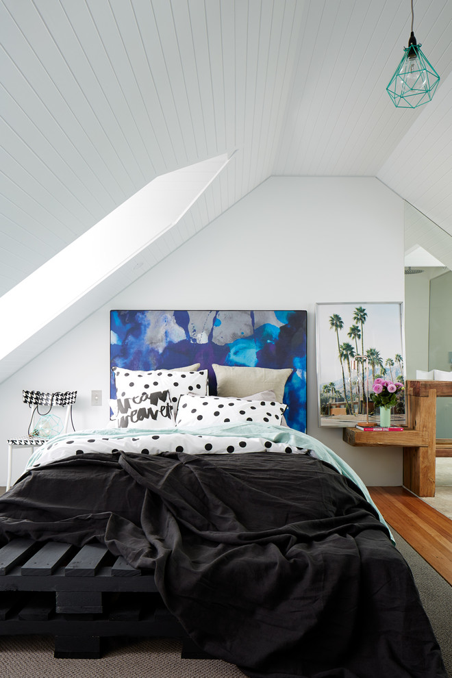 This is an example of a beach style loft bedroom in Sydney.