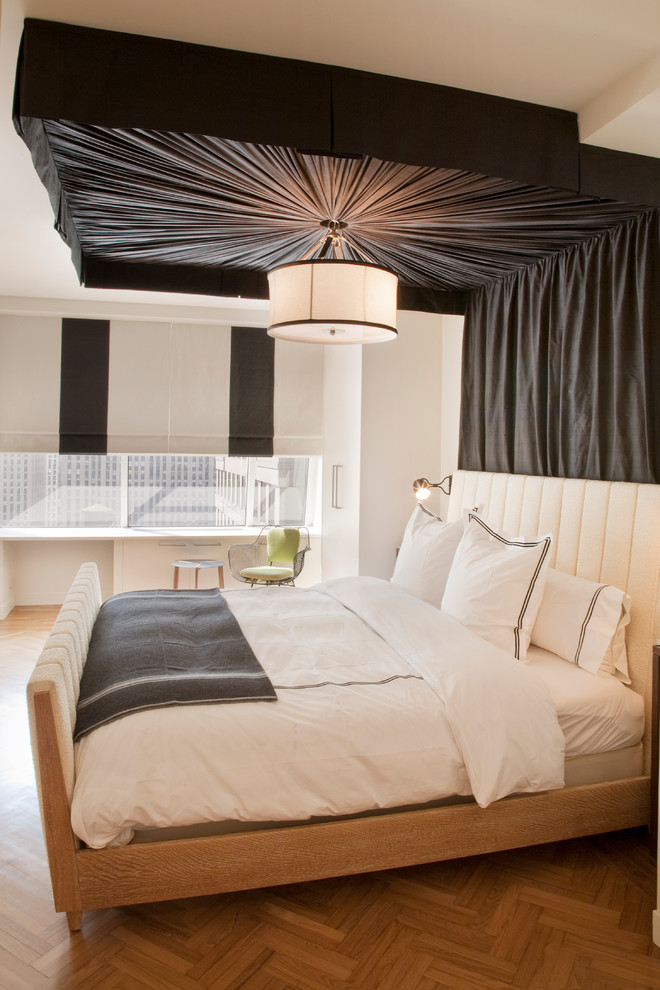 Rustic bedroom in New York with multi-coloured walls and medium hardwood flooring.