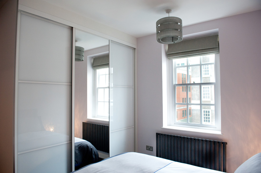 Bedroom - mid-sized modern master dark wood floor bedroom idea in London with white walls