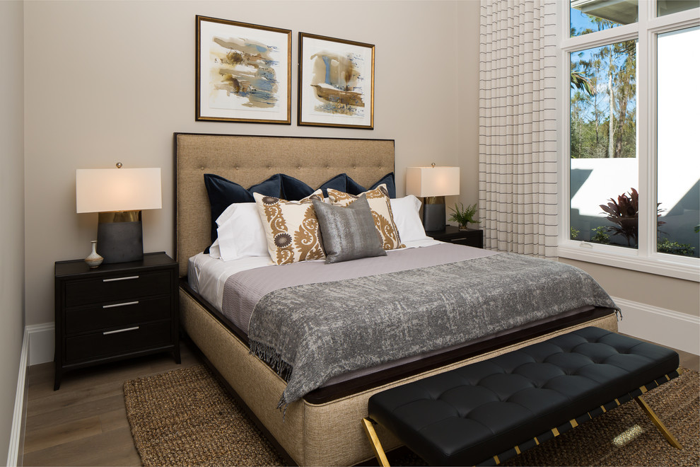 Design ideas for a classic grey and brown bedroom in Miami with beige walls, medium hardwood flooring and brown floors.