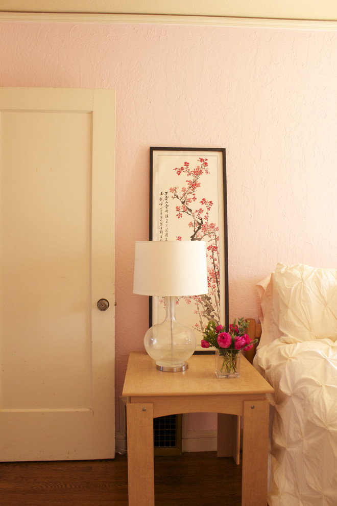 Eclectic master medium tone wood floor bedroom photo in San Francisco with pink walls