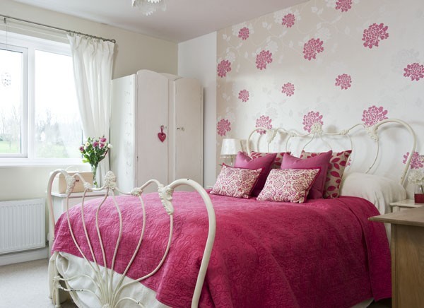Design ideas for a small rustic master bedroom in Devon with pink walls and carpet.