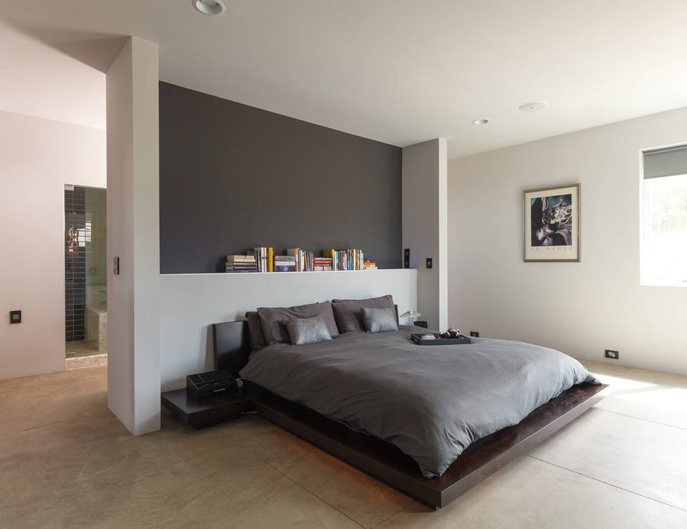Bedroom - industrial concrete floor bedroom idea in Albuquerque with white walls