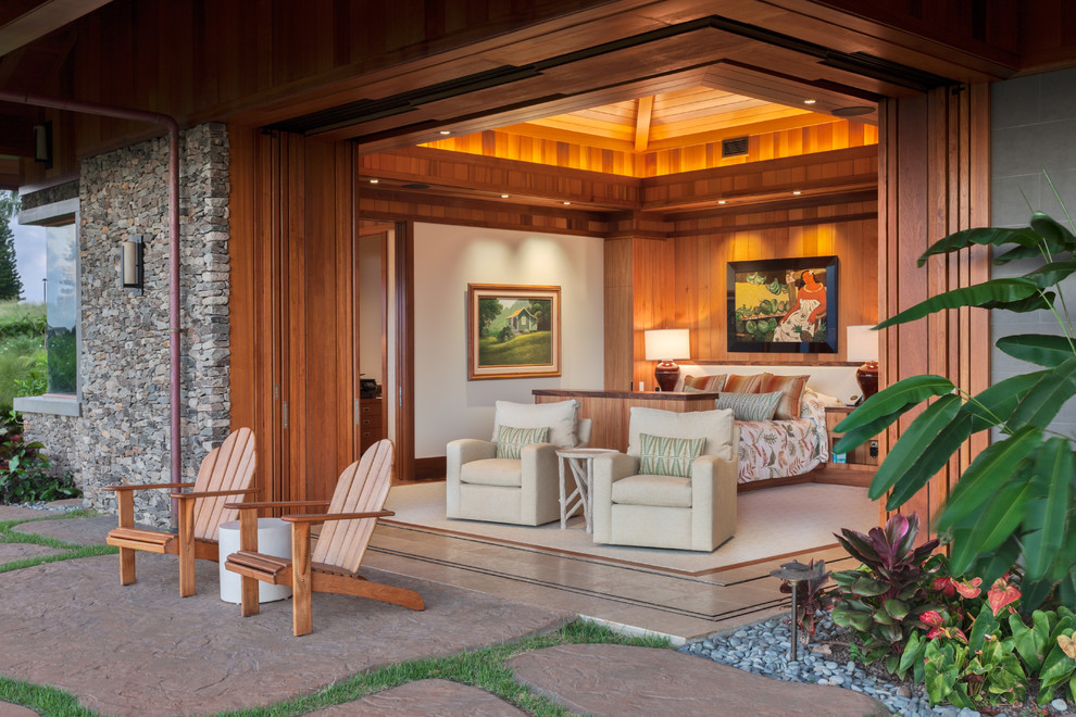 Example of a large island style master beige floor and carpeted bedroom design in Hawaii with beige walls and no fireplace