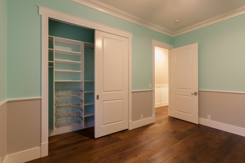 Diseño de habitación de invitados clásica renovada de tamaño medio sin chimenea con paredes azules, suelo de madera oscura y suelo marrón