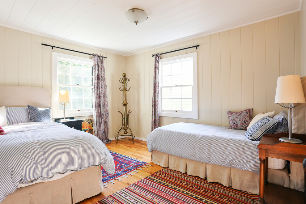 Design ideas for a rural bedroom in San Francisco with yellow walls, medium hardwood flooring and no fireplace.